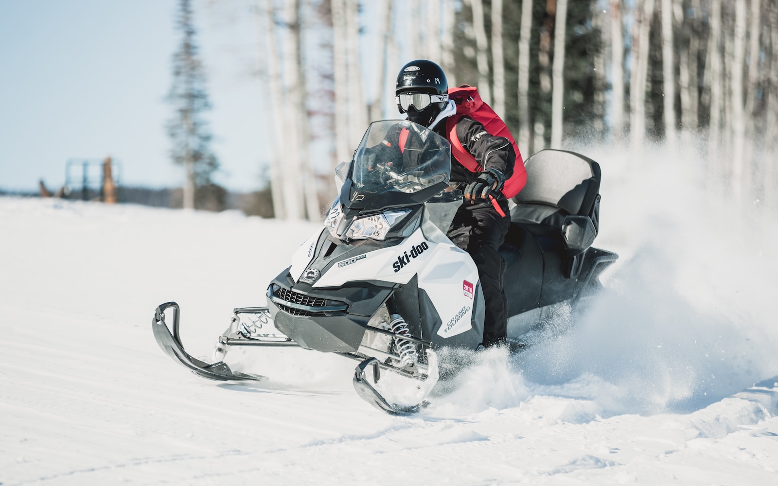 person riding snow mobile during daytime